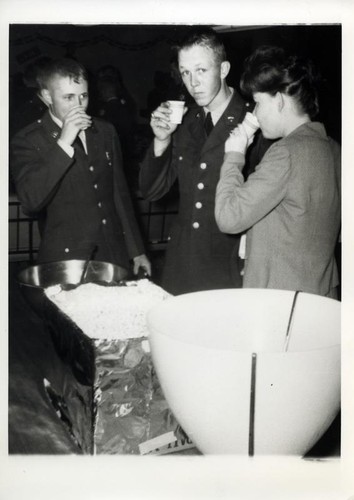 Two young men in uniform and a woman