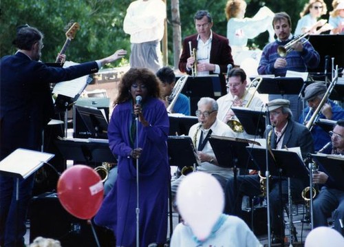 Woman singing with a band