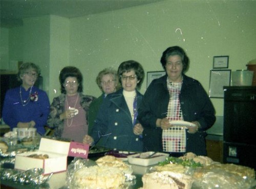 Women at a counter filled with food