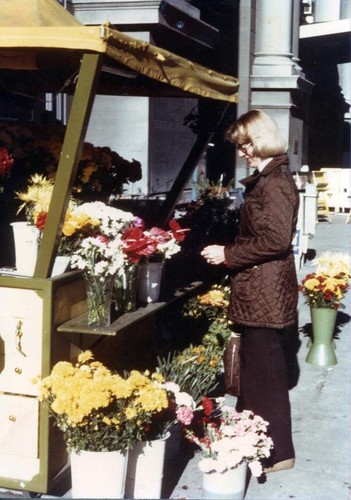 Tina May standing by a flower stand