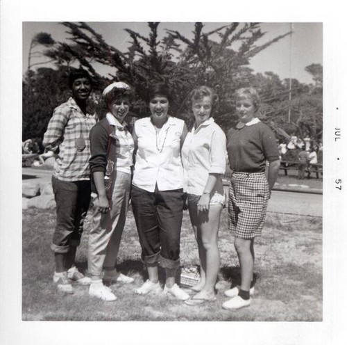 Teenage girls posing outdoors with a woman