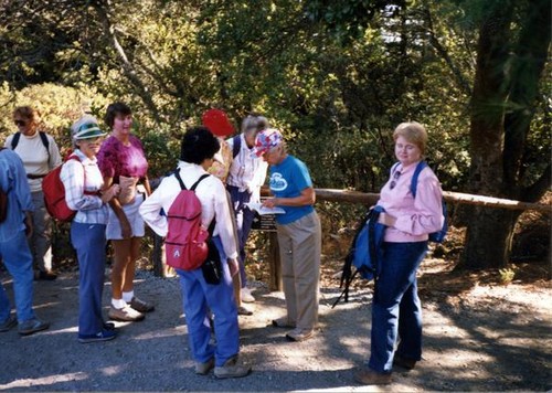 Women milling around on a hiking trail