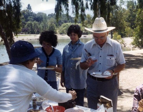 Four people serving themselves food