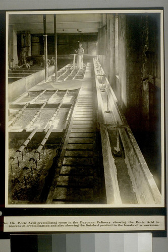 Boric Acid crystallizing room in the Bayonne Refinery showing the Boric Acid in process of crystallization and also showing the finished product in the hands of a workman