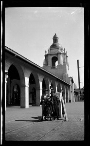 Three people posing for a picture in front of the Santa Fe Depot in San Diego