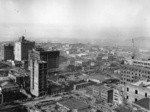 [View of Wholesale District looking northeast during reconstruction. From atop Chronicle Building? Merchants Exchange Building and Mills Building, left; Ferry Building, right]