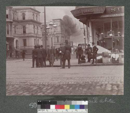 [Police officers, soldiers, and onlookers at Market and Fifth Sts., with fire burning in distance. Lincoln School second building from left.]