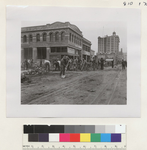 [Street cleaning effort. California St. at Battery? Merchants' Exchange Building, right.]