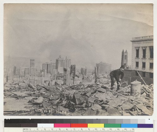 Ruins from Fairmount [sic] Hotel. [Nob Hill. Man digging through rubble near Fairmont Hotel, right. Old St. Mary's Church and Merchants' Exchange Building, center; Grace Church, right center; Ferry Building, far left. Photo by Florey.]