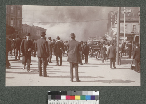 [Crowd at foot of Market St. watcing fire in distance. Near Sacramento St.]