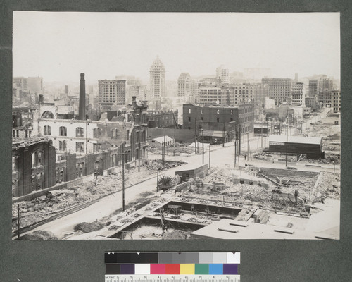 [South of Market area during reconstruction. View north along Secon St. Call Building, left center; Fairmont Hotel in distance, right center.]