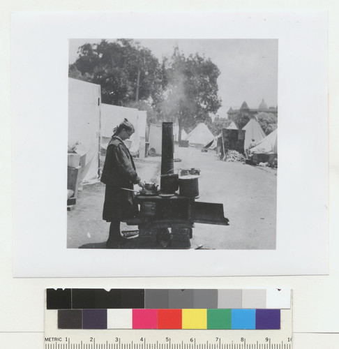 [Woman cooking at outdoor kitchen. Unidentified refugee camp.]