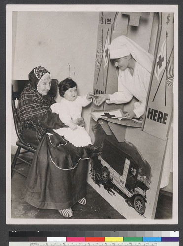 [Elderly woman with young girl and nurse at Red Cross membership booth.]