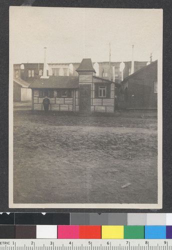 [Child standing beside building. Unidentified refugee camp.]