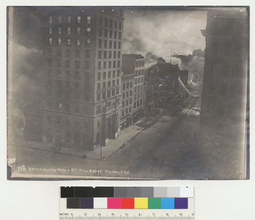 Last stream of water on Sanborn Vail's. Market St. No. 115. [Call Building at Third St., left center; Chronicle Building, right; fire fighters battling flames in distance.]