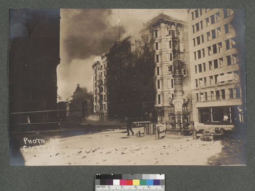 [Palace Hotel and Grand Hotel on Fire. From corner of Market, Kearny and Geary Sts. Lotta's Fountain, foreground; Chronicle Building at left.]