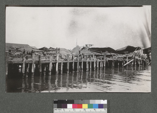 [Collapsed structures atop pier. Unidentified location.]