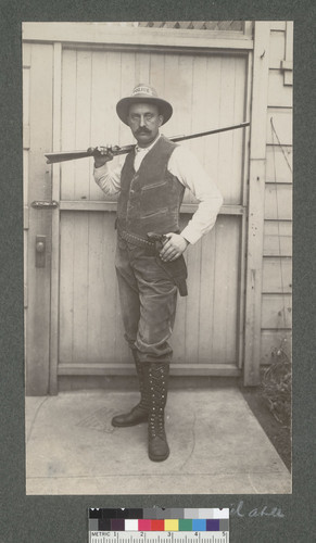 [Unidentified police officer posing with guns.]