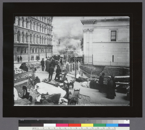 [Street scene during fire showing refugees with belongings. Jones St. looking toward Market. Hibernia Bank, right.]