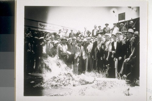 Longshoremen burning pink books (or blue books?) after winning short strike against Matson, September 1933