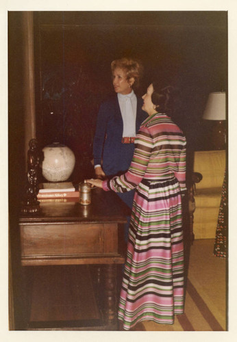 Mrs. Alice Tyler and a guest admiring a painting in the Brock House--Pose 2 (Color)
