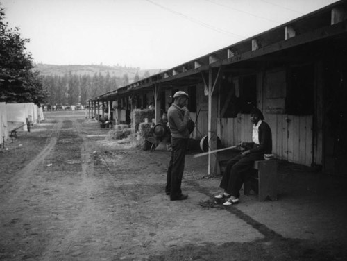 Man and woman in front of stables at Los Angeles County Fair
