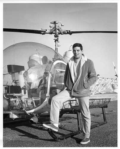 Image of an Unidentified Male Standing Next to a Helicopter