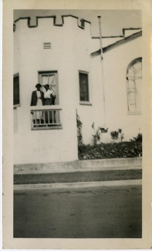 Two African American women on balcony of house
