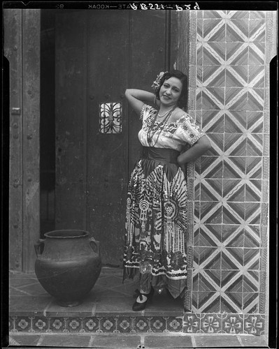 Woman in traditional Mexican dress in front of Hotel Playa de Ensenada, Ensenada, 1931