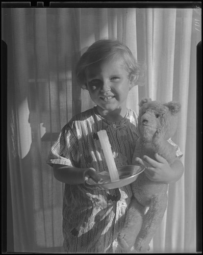 Girl with teddy bear and candle, Los Angeles, circa 1935