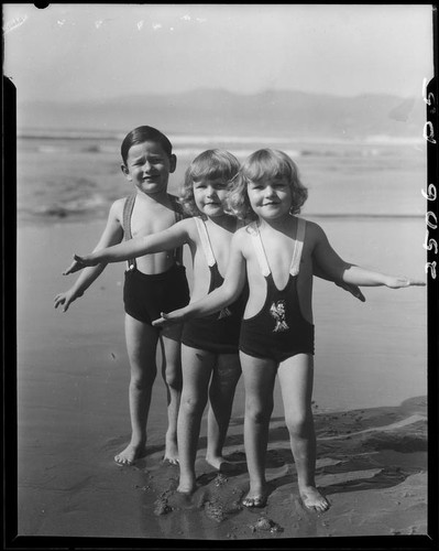 Patsy, Peggy, and Tommy Morgan posing on beach, Santa Monica, 1929