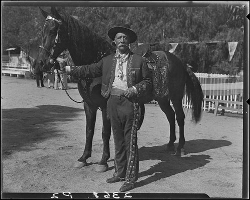 Eugene R. Plummer with horse, Hollywood, 1931