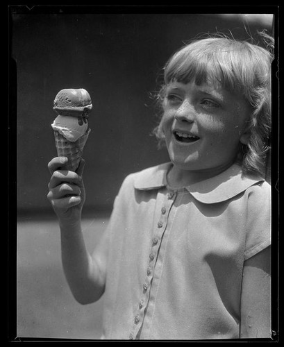 Girl eating an ice cream cone from a concession at Abbot Kinney Pier, Venice, 1928