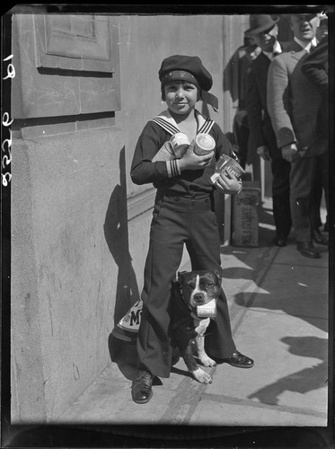 Child actor Jackie Coogan with cans of condensed milk, [1924]