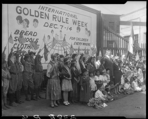 William Gibbs McAdoo and group posing with billboard advertising Golden Rule Week at Golden Rule Foundation Pageant, Los Angeles, 1930