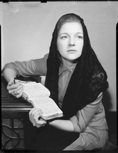 Betty Hanna in mantilla with Bible, 1941