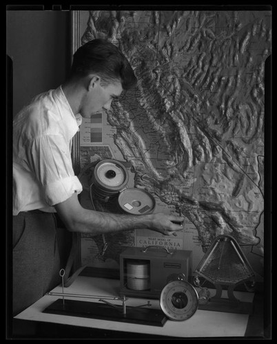 Los Angeles City College student with map and weather equipment, Los Angeles, circa 1933-1938