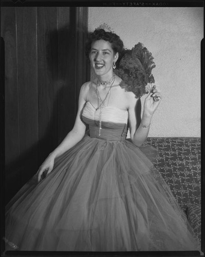 Opera performer Diane Houck Malin wearing a tulle gown with tiara and fan, 1956