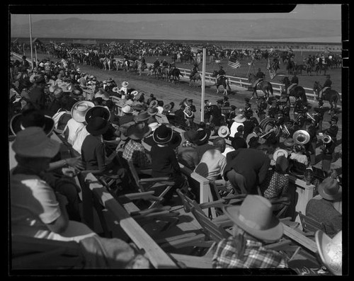 Horseback riders and band at Desert Circus Rodeo on parade grounds at Palm Springs Field Club, Palm Springs, 1938