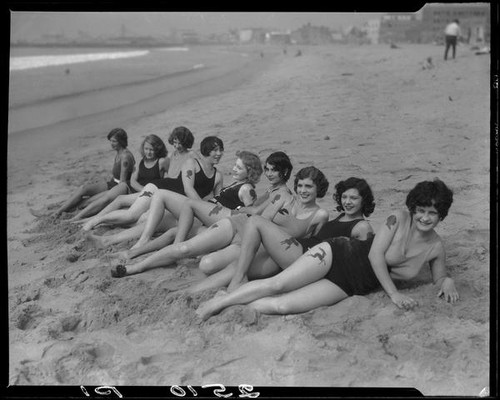 Young women sunbathing with paper silhouettes applied to skin, Venice, 1930