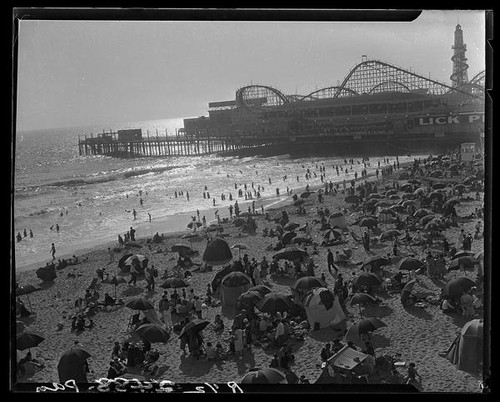 Bird's-eye view of crowded beach, Lick Pier, and Ocean Park Pier, Venice and Santa Monica, 1928