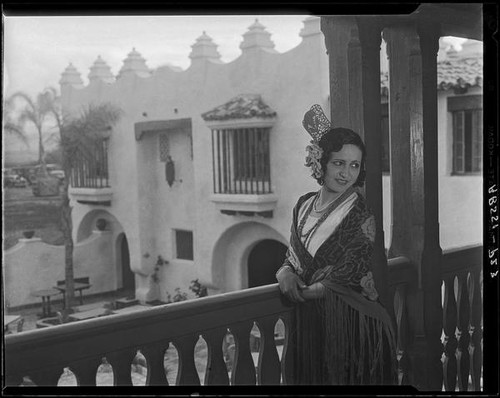 Woman in fringed shawl on balcony of the Hotel Playa Ensenada, Ensenada, 1931