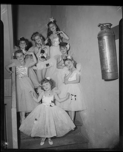 Helena Burnett and other child ballerinas pose on staircase, 1947-1950