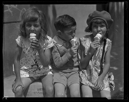 Three children eating ice cream cones from a concession at Abbot Kinney Pier, Venice, 1928