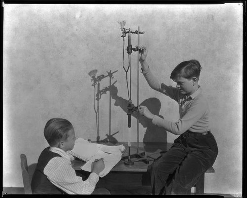 Two school boys at Thomas Starr King Junior High School demonstrate a science experiment, Los Angeles, circa 1933