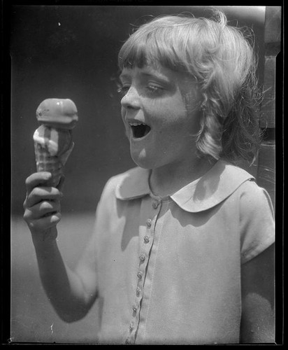 Girl eating an ice cream cone from a concession at Abbot Kinney Pier, Venice, 1928