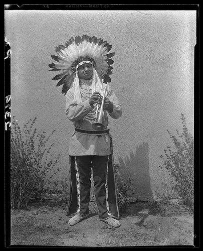 Young man in Indian regalia with trumpet, 1928