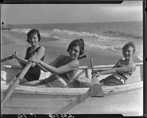 Young women posing in rowboat on beach, Pacific Palisades, 1927