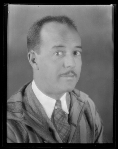 Portrait of Darrel B. Foss, in suit, tie, and striped overcoat, 1924