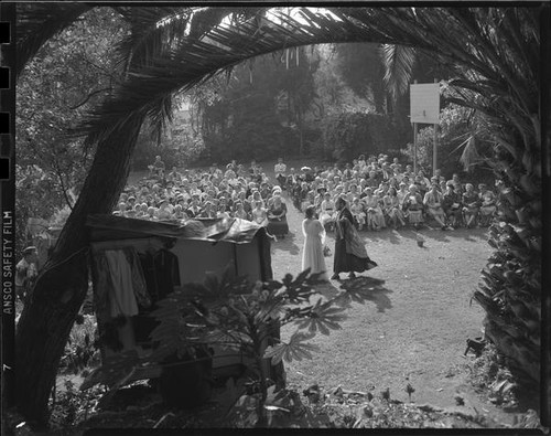 Audience watching outdoor theatrical performance, perhaps Shakespeare, [Santa Monica?], 1956-1957